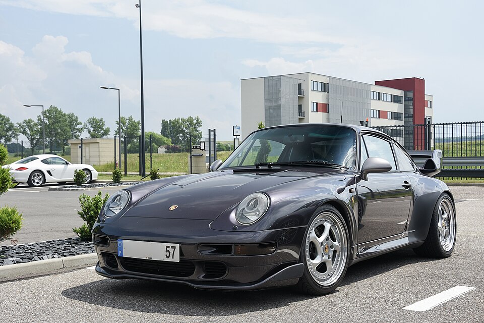 Dark Porsche 993 Carrera S coupe viewed from the front left